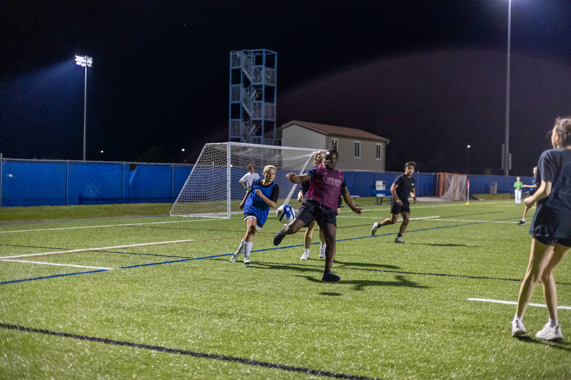 intramural soccer players attacking the ball
